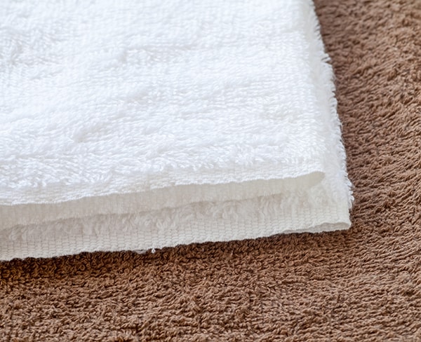 White clean towel on brown towel background